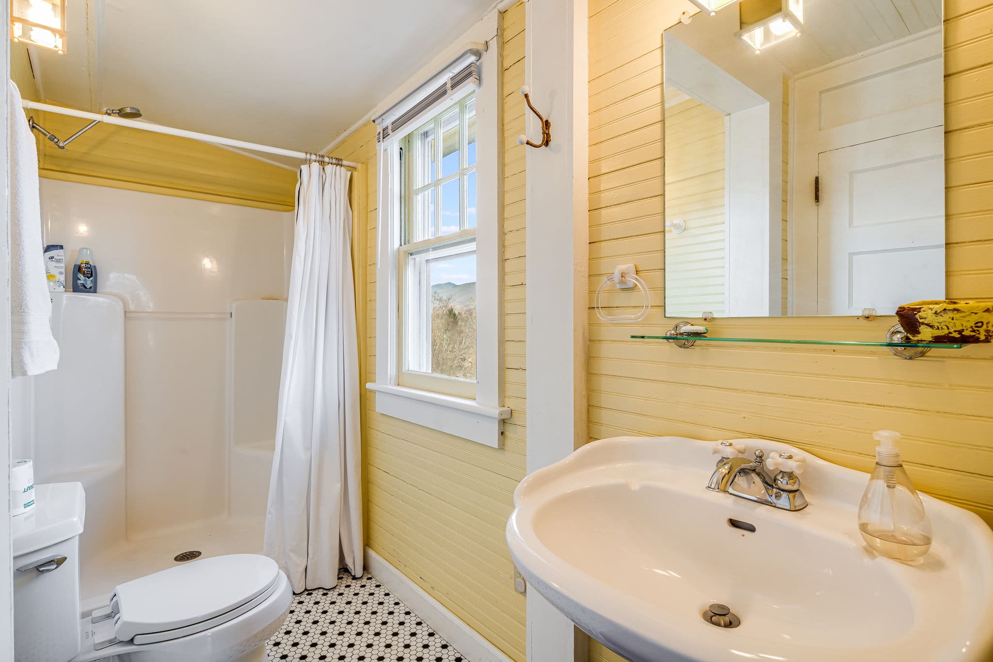 bathroom sink, mirror, shower, tiled floor, window, toilet